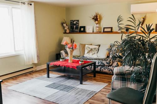 a living room with a couch and a table at 2 bedrooms home in Kentville in Kentville