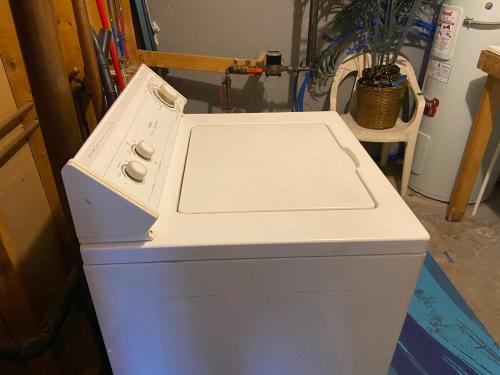 a white stove top oven sitting in a room at 2 bedrooms home in Kentville in Kentville
