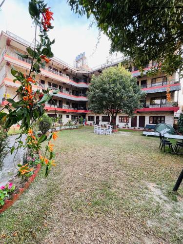 a large building with a yard in front of it at Butterfly Lodge in Pokhara