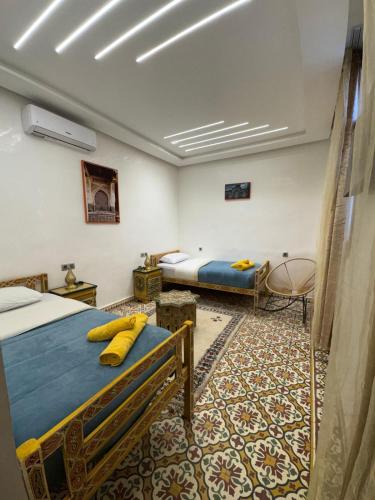 a bedroom with two beds in a room at Appartement Dar LALA 2 in Fez