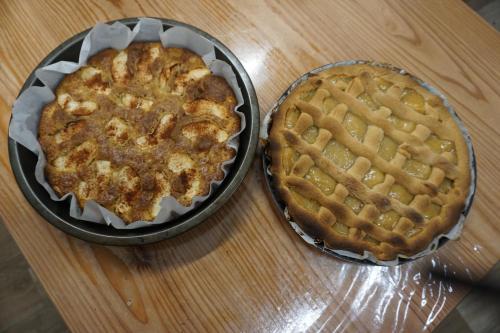 two pies sitting on top of a wooden table at Agriturismo U muinettu in La Spezia