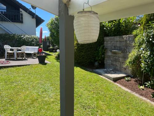 a backyard with a table and a lamp at Sauerland Blick in Balve