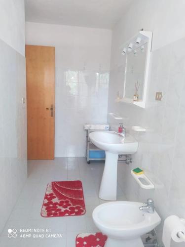 a bathroom with a sink and a toilet and a mirror at Tropea CAPO VATICANO villa - Amphitrite in Capo Vaticano