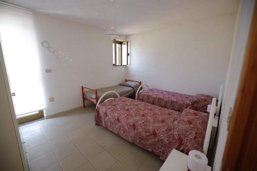 a room with two beds and a couch and a window at Tropea CAPO VATICANO villa - Amphitrite in Capo Vaticano