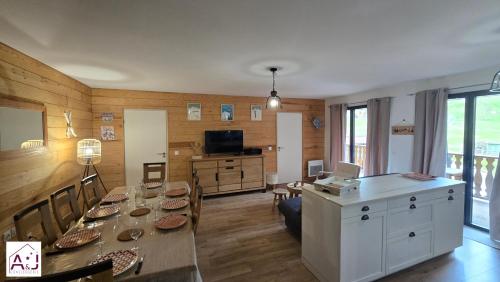 a living room with a table and a dining room at L'Etoile du Berger Chalet des Etoiles 8 pers in Bagnères-de-Bigorre