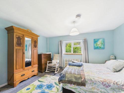 a bedroom with a bed and a dresser and a window at The Hazels in Staunton