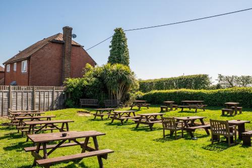 a group of picnic tables and chairs in the grass at The Evenhill in Canterbury