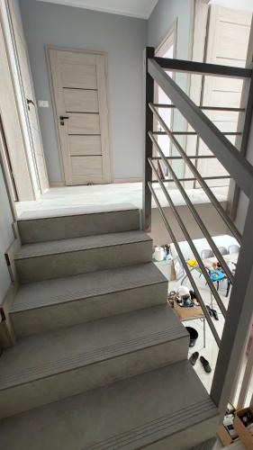 a stairway leading to a hallway with a door at Domek Liliowe Marzenie in Chrzanów