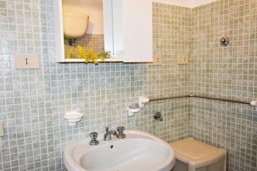 a bathroom with a sink and a toilet at Tramonti sul mare in Pantelleria