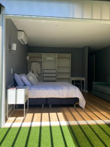 a bedroom with a large bed and green grass at Casa ORO VERDE in San Luis