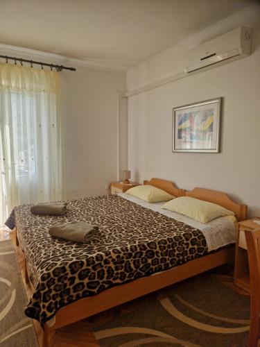 a bedroom with a large bed in a room with a window at Rooms Slade in Mali Ston