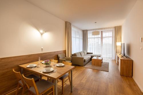 a living room with a table and a couch at Hrebienok Apartman D4 in Vysoké Tatry