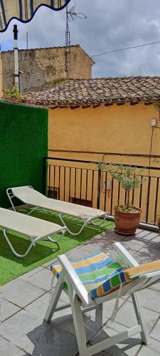 a couple of chairs and a table on a patio at Casa TEO in Entrena
