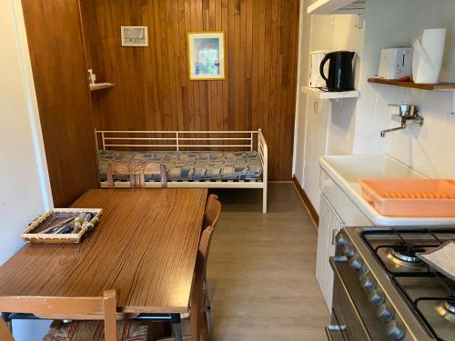 Il comprend une petite cuisine avec une table et des lits superposés. dans l'établissement Le tourbillon, à La Bourboule