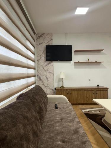 a living room with a couch and a flat screen tv at Stella 3 Apartment in Negotino