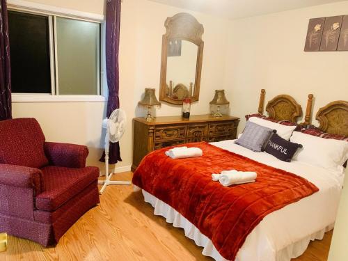 a bedroom with a bed and a chair and a mirror at 3 bedrooms home in Kentville