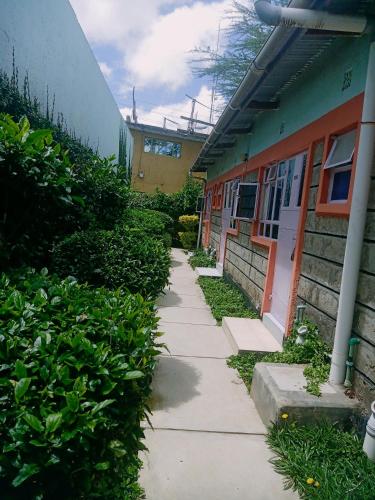 a sidewalk in front of a building with a building at Cis Mara Acacia Motel in Narok