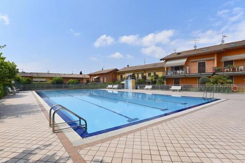 a large swimming pool in front of a building at HildeGarda Pacengo in Pacengo di Lazise