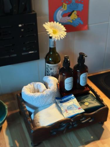 a tray with two bottles of soap and a flower at candy house ที่พักวัวลาย เชียงใหม่ in Chiang Mai