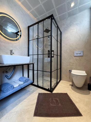 a bathroom with a shower and a sink and a toilet at Sky Luxe Hotel Konyaaltı in Antalya