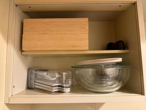 a cupboard with bowls and other kitchen items on it at Stylish ROCO house Omori8min in Tokyo