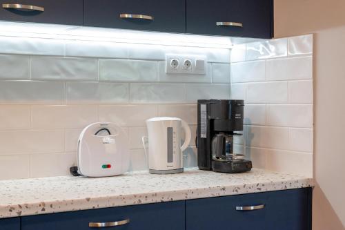 a kitchen counter with a coffeemaker and a coffee maker at Laki's Place in Chrani