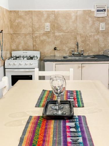 a wine glass sitting on a table in a kitchen at KAKAN - Dpto 2 dormit- Primer piso in Cafayate