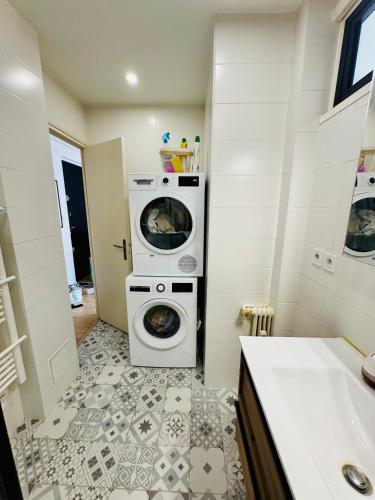 a bathroom with a washing machine and a washer and dryer at Nice experience in Nice
