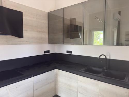 a kitchen with a sink and a counter top at Villa Gioia in Is Molas 