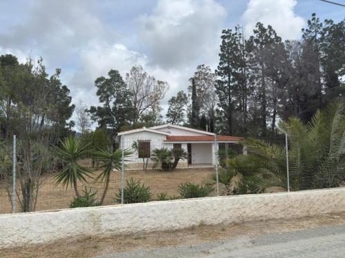 a small white house in the middle of a forest at Villa Gioia in Is Molas 