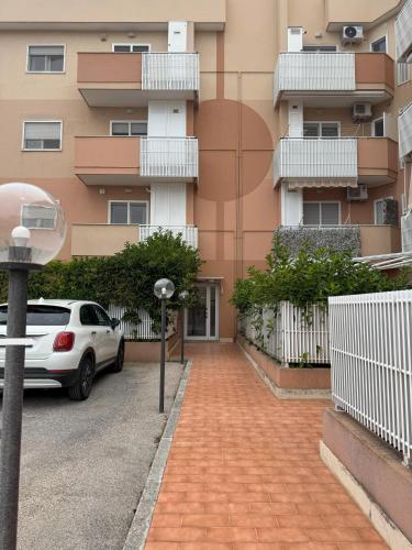 a car parked in a parking lot in front of a building at A casa di Lorenza in Taranto