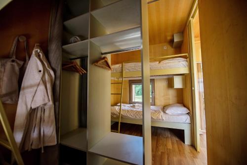 a mirror in a room with a bunk bed at VRBA mobile house by the Kolpa river BIG BERRY Metlika in Metlika
