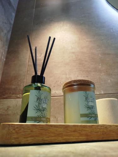 two jars sitting on a shelf with sticks in them at Simple and Relaxing House! in Kalamata