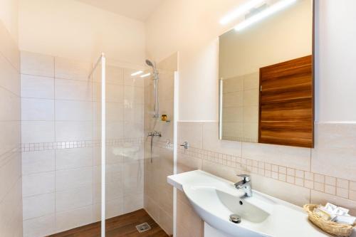 a bathroom with a sink and a shower at B&B Lajta Park in Mosonmagyaróvár