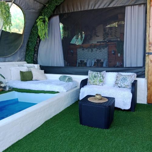 a room with two beds and a couch and a table at The Jolly Joint Clarens in Clarens