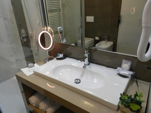a bathroom with a sink and a mirror at Boutique Hotel Kotoni in Tirana