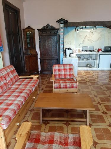 a living room with two couches and a table at villamuna in Ferentillo