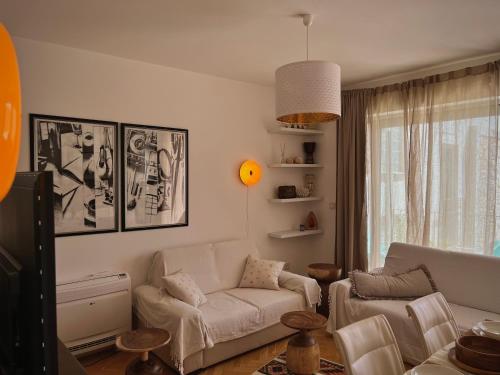 a living room with a couch and a chair at The Legendary Apartment in Dobrota