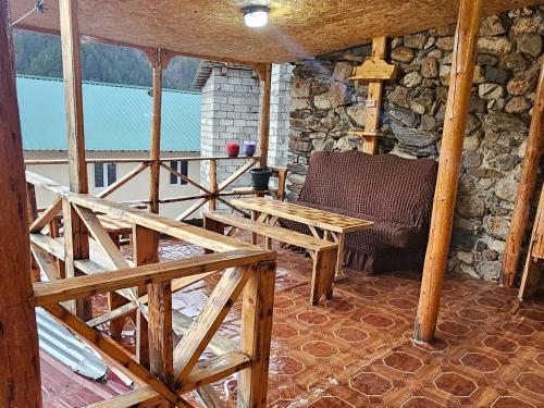 a room with a table and a chair in a cabin at MURQVAMI Guesthouse in Adishi