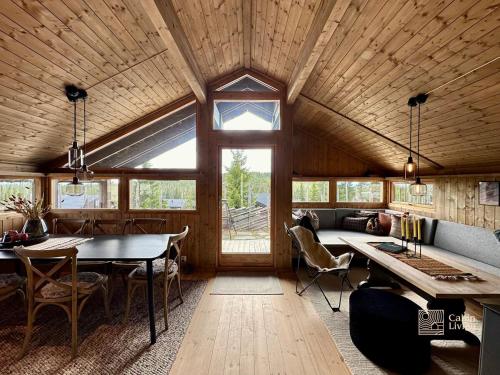 a room with a table and chairs in a room at Modern mountain cabin Ski in-out 2 Bathrooms in Ringsaker