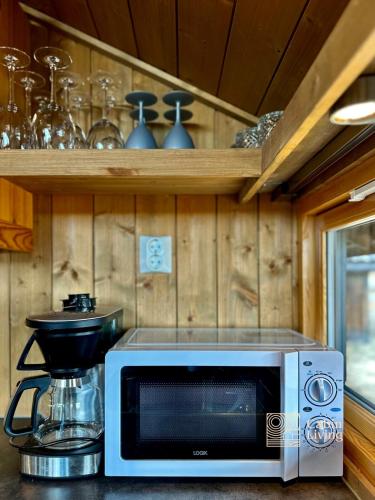 a microwave sitting on a counter in a kitchen at Modern mountain cabin Ski in-out 2 Bathrooms in Ringsaker