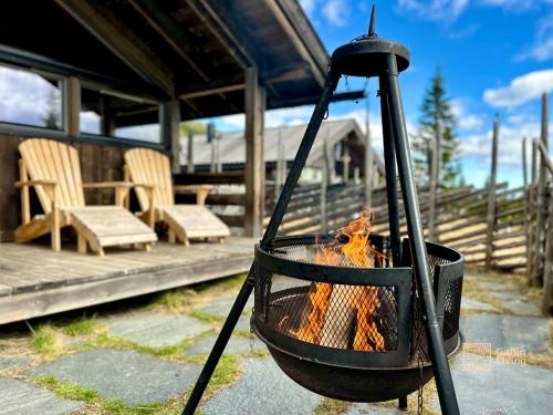 a fire in a pot on a patio at Modern mountain cabin Ski in-out 2 Bathrooms in Ringsaker