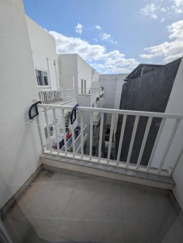 a balcony of a building with a white railing at Private cosy room in a modern suburban penthouse in Luqa