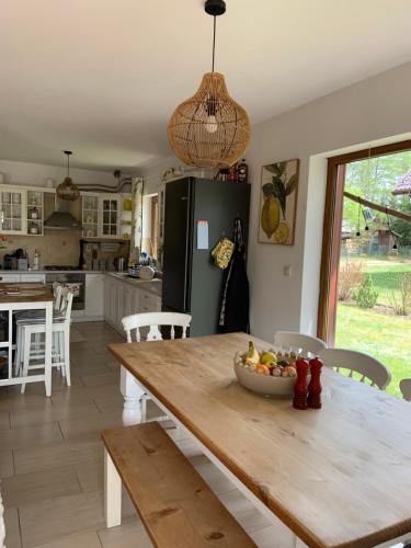 a kitchen with a wooden table with a bowl of fruit on it at Lavender Cottage in Sucha Rzeczka