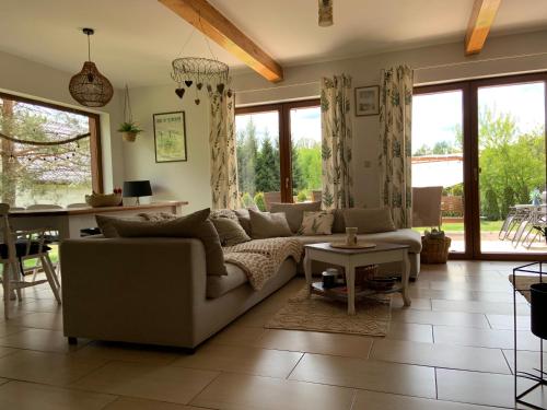 a living room with a couch and a table at Lavender Cottage in Sucha Rzeczka