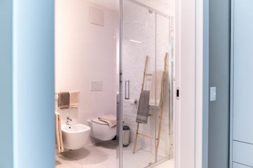 a bathroom with a toilet and a glass shower at Locarno Center - Free Parking, Netflix and WiFi in Locarno