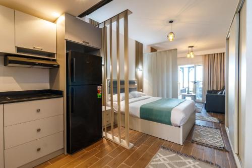 a hotel room with a bed and a kitchen at Studio with Pool View C106 -Al Saraya Sahl Hasheesh by Peaks in Hurghada