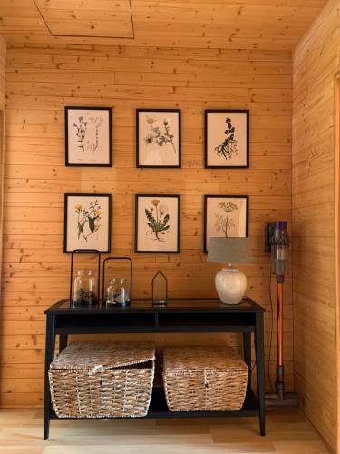 a room with a table and framed pictures on the wall at Lavender Cottage in Sucha Rzeczka