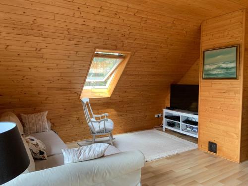 a living room with a couch and a television at Lavender Cottage in Sucha Rzeczka