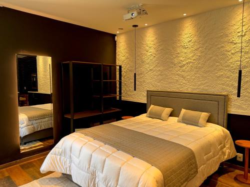 a bedroom with a large bed in a room at Exclusive Cabanas in Serra Negra